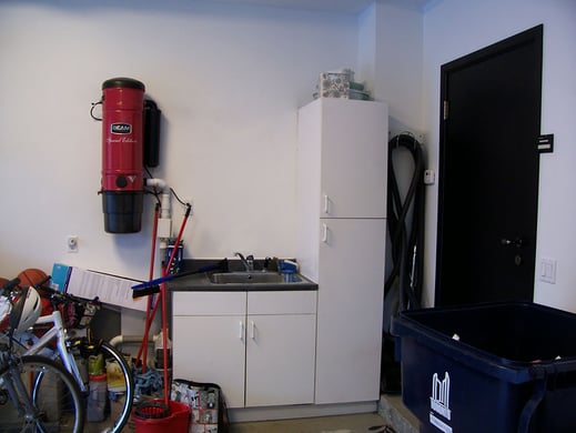 Inexpensive melamine kitchen/laundry room cabinetry provided inadequate storage space.