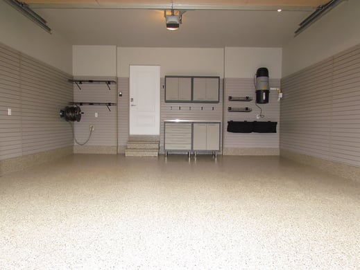 Garage was primed and painted. The floor was finished with a Khaki Floortex® floor coating. The temporary wooden steps were replaced with precast concrete steps and given the same coating as the floor.  Installed slatwall panels to a height of 6 feet around the perimeter of the garage which provides a lot of flexibility for future storage and organization.